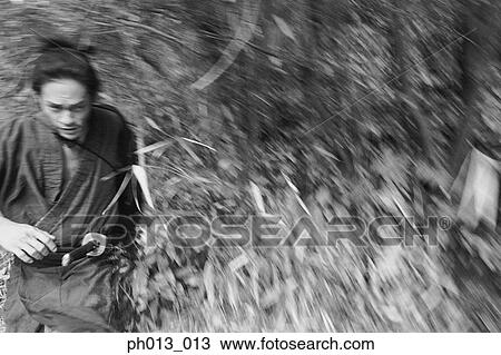 Samurai warrior running in an isolated land View Large Photo Image Stock Image - Samurai warrior running in an isolated land. Fotosearch