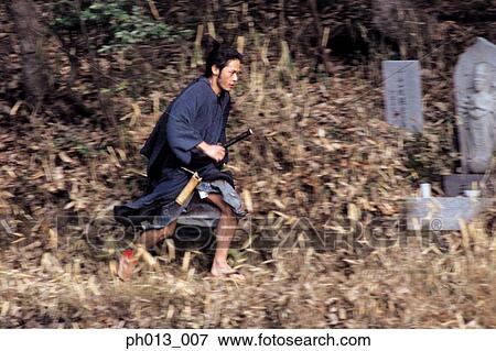 Samurai warrior running in an isolated land View Large Photo Image Stock Photo - Samurai warrior running in an isolated land. Fotosearch