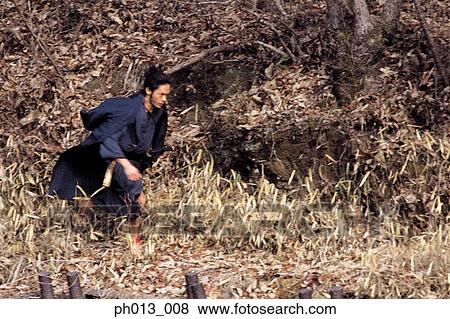 Stock Photo - Samurai warrior running in an isolated land. Fotosearch