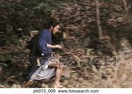 Stock Photo - Samurai warrior running in an isolated land. Fotosearch