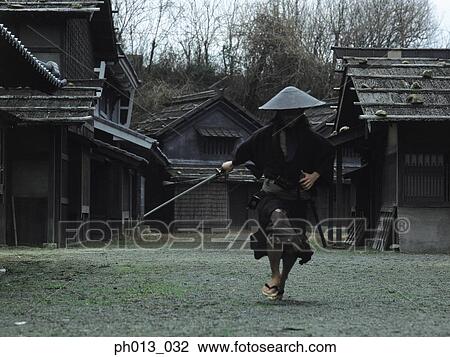 Stock Image - Samurai warrior running with a sword in his hand. Fotosearch