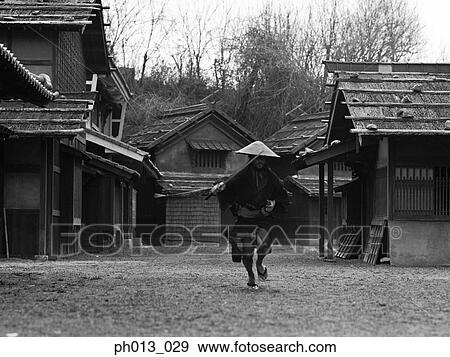 Stock Photo - Samurai warrior running with a sword in his hand. Fotosearch