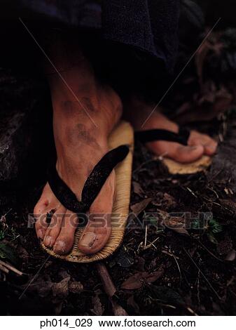 Stock Photo - A pair of man's feet in Japanese slippers. Fotosearch