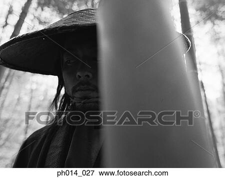 Stock Photo - Portrait of a Japanese man in cone hat. Fotosearch