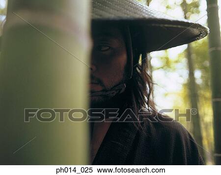 Stock Photography - Portrait of a Japanese man in cone hat. Fotosearch