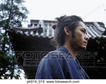 Stock Image - Portrait of a Japanese man in traditional costume. Fotosearch