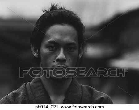 Stock Image - Portrait of a Japanese man in traditional costume. Fotosearch