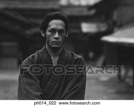 Stock Image - Portrait of a Japanese man in traditional costume. Fotosearch