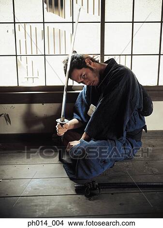 Picture - Samurai warrior holding a sword. Fotosearch