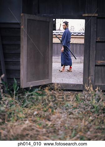 Samurai warrior standing in an open area View Large Photo Image Stock Image - Samurai warrior standing in an open area. Fotosearch