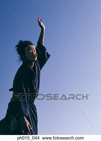 Portrait of a Japanese man in traditional costume wearing a mask View Large Photo Image Picture - Portrait of a Japanese man in traditional costume wearing a mask. Fotosearch