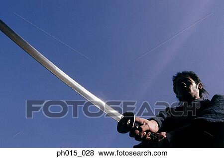 Stock Photo - Samurai warrior attacks with a sword. Fotosearch