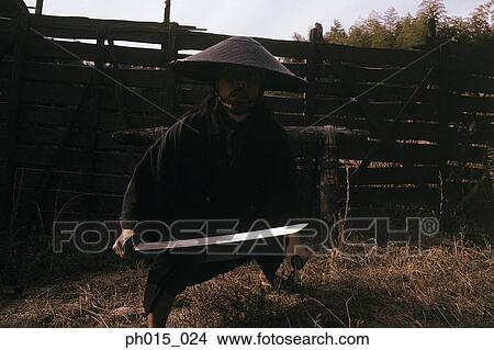 Samurai warrior prepares to fight with a sword View Large Photo Image Picture - Samurai warrior prepares to fight with a sword. Fotosearch