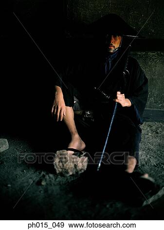 Stock Photo - Samurai warrior sitting holding a sword. Fotosearch