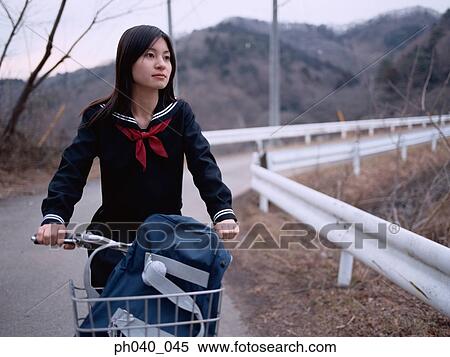 School girl cycling along the road View Large Photo Image Stock Photography - School girl cycling along the road. Fotosearch