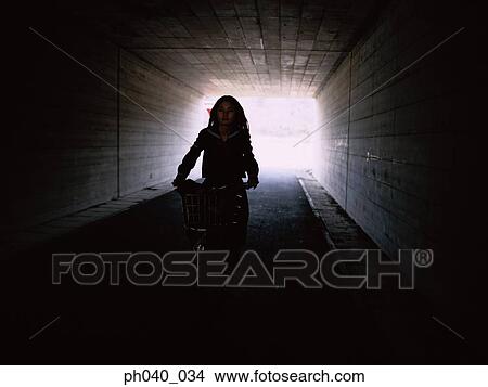 School girl cycling in the tunnel View Large Photo Image Picture - School girl cycling in the tunnel. Fotosearch