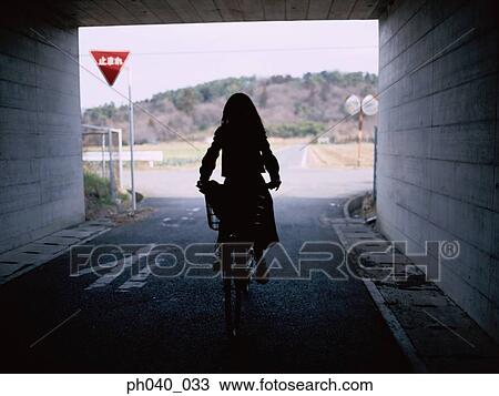 School girl cycling in the tunnel View Large Photo Image Stock Image - School girl cycling in the tunnel. Fotosearch