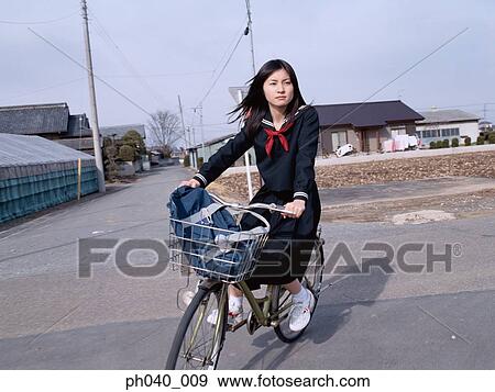School girl cycling on a bicycle View Large Photo Image Stock Photo - School girl cycling on a bicycle. Fotosearch