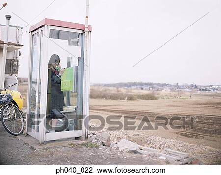 School girl in a public phone booth View Large Photo Image Stock Image - School girl in a public phone booth. Fotosearch