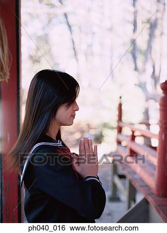 School girl praying outside a shrine View Large Photo Image Stock Photograph - School girl praying outside a shrine. Fotosearch