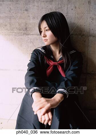 School girl sitting against a wall View Large Photo Image Stock Photograph - School girl sitting against a wall. Fotosearch