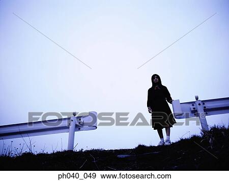 School girl standing between two road dividers View Large Photo Image Stock Photo - School girl standing between two road dividers. Fotosearch