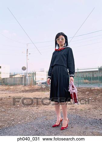 School girl standing in front of an industrial area View Large Photo Image Stock Image - School girl standing in front of an industrial area. Fotosearch