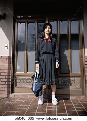 School girl standing in front of the door View Large Photo Image Stock Photography - School girl standing in front of the door. Fotosearch