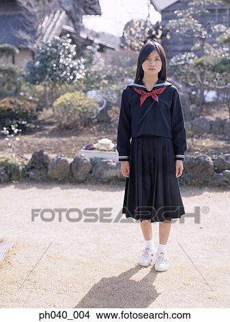 School girl standing in the front yard View Large Photo Image Picture - School girl standing in the front yard. Fotosearch