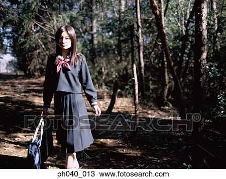 School girl walking in a park View Large Photo Image Stock Image - School girl walking in a park. Fotosearch