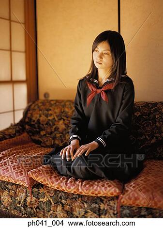 School girl kneeing on a sofa View Large Photo Image Picture - School girl kneeing on a sofa. Fotosearch