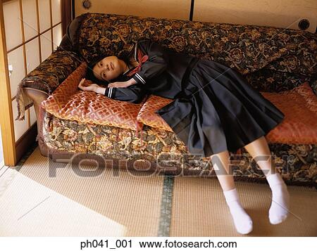 School girl lying on a sofa View Large Photo Image Stock Image - School girl lying on a sofa. Fotosearch