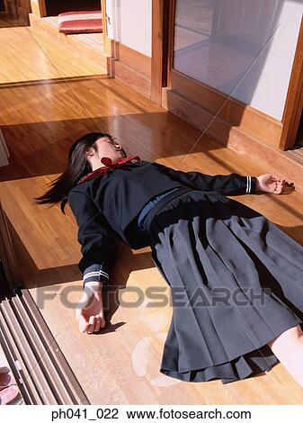 School girl lying on the floor View Large Photo Image Stock Image - School girl lying on the floor. Fotosearch