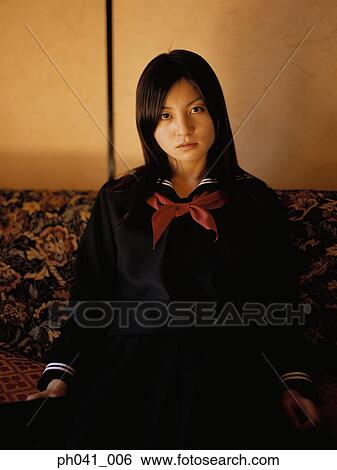 School girl sitting on a sofa View Large Photo Image Stock Photograph - School girl sitting on a sofa. Fotosearch