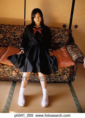 School girl sitting on a sofa View Large Photo Image Stock Photography - School girl sitting on a sofa. Fotosearch