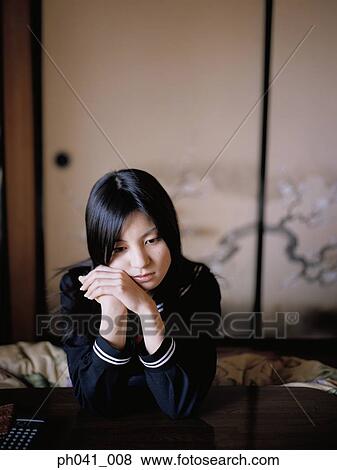 School girl sitting with arms leaning on the table View Large Photo Image Stock Photo - School girl sitting with arms leaning on the table. Fotosearch