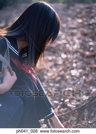 School girl squatting View Large Photo Image Stock Photo - School girl squatting. Fotosearch