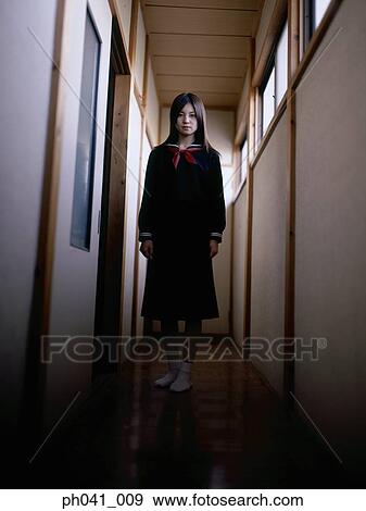 Stock Photo - School girl standing at the corridor. Fotosearch