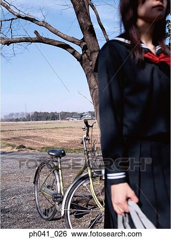 School girl standing in an isolated land View Large Photo Image Stock Photograph - School girl standing in an isolated land. Fotosearch
