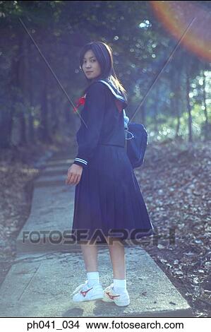 Picture - School girl walking up the steps. Fotosearch