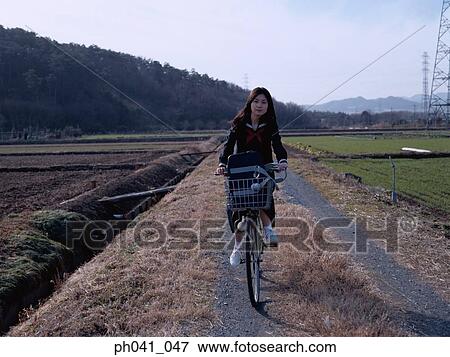 School School girl cycling View Large Photo Image Stock Photo - School School girl cycling. Fotosearch