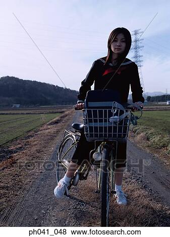 School School girl cycling View Large Photo Image Stock Photo - School School girl cycling. Fotosearch