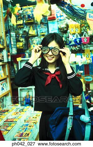 Stock Photo - School girl at a shop. Fotosearch