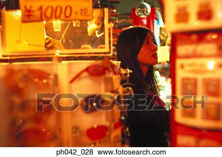 Stock Photo - School girl at a shop. Fotosearch