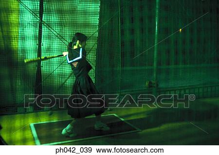 Stock Photo - School girl holding a baseball bat. Fotosearch