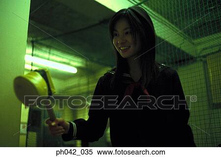 Stock Photography - School girl holding a toy hammer. Fotosearch