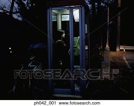 School girl in a public telephone booth View Large Photo Image Stock Image - School girl in a public telephone booth. Fotosearch