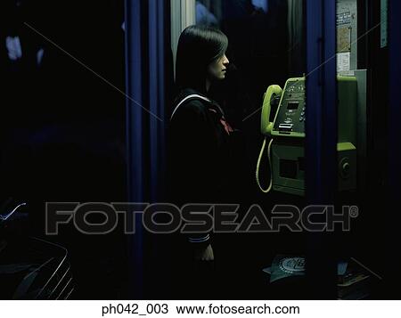 School girl in a public telephone booth View Large Photo Image Stock Image - School girl in a public telephone booth. Fotosearch