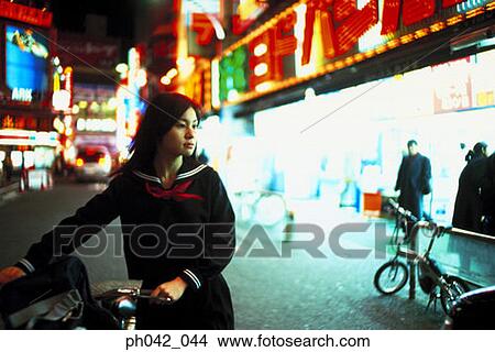 School girl pushing a bicycle View Large Photo Image Picture - School girl pushing a bicycle. Fotosearch