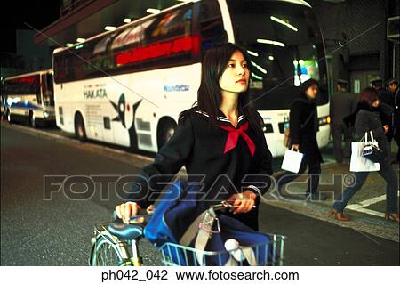 School girl pushing a bicycle View Large Photo Image Stock Image - School girl pushing a bicycle. Fotosearch